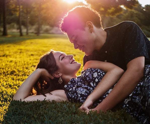 Compatible male and female lying on the grass, the benefit of personality type dating