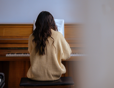 woman playing piano alone creative