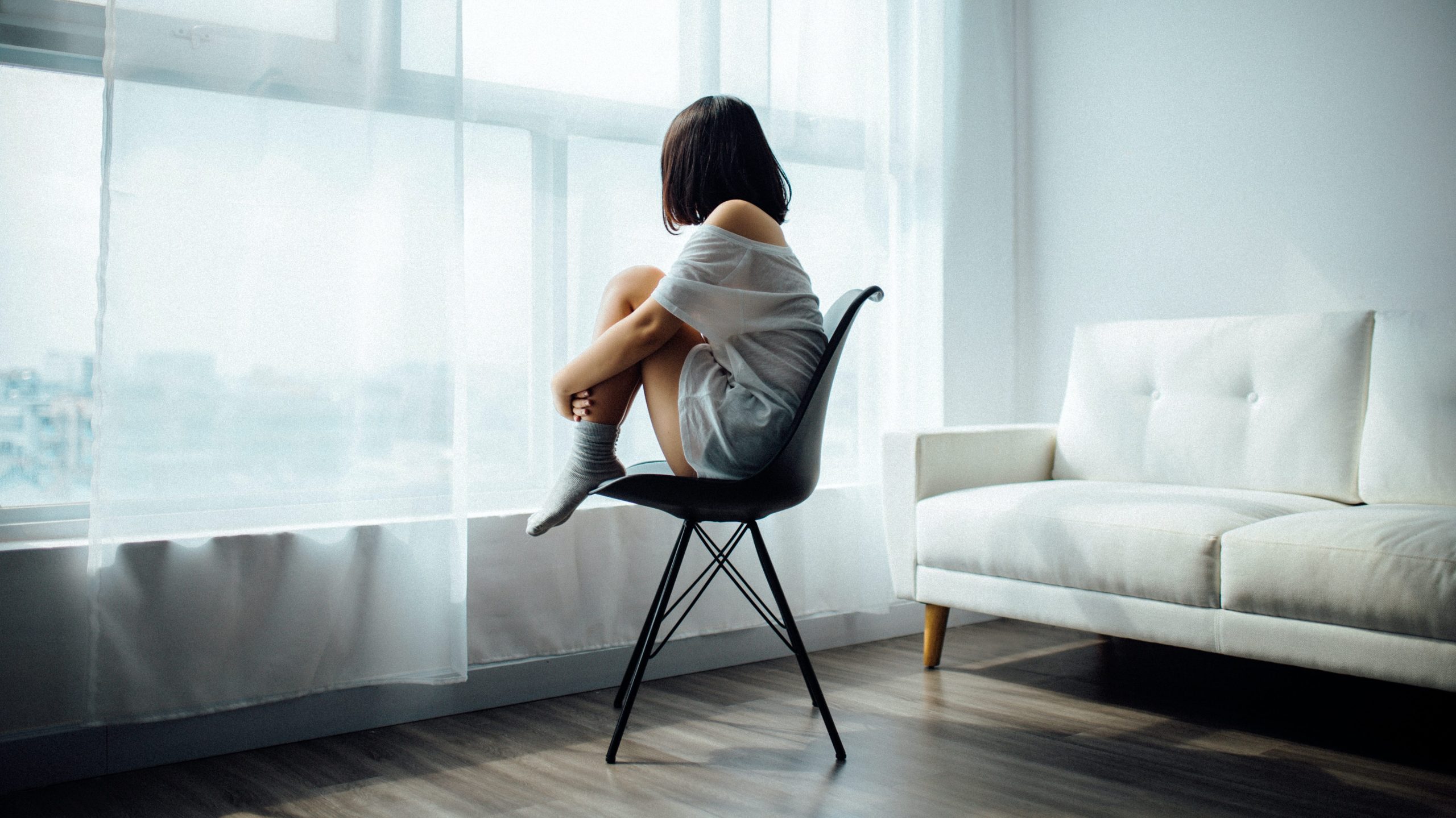 woman sitting on chair staring deeply